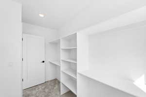 Spacious closet with light colored carpet