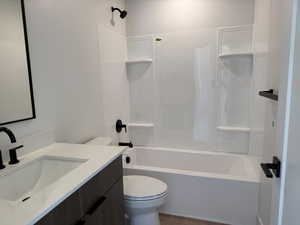 Full bathroom with vanity, bathtub / shower combination, and wood finished floors