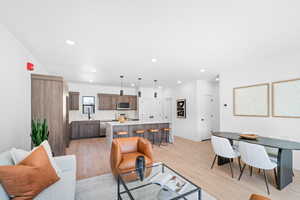 Living area with light wood-style floors and recessed lighting