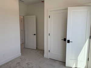 Unfurnished bedroom featuring carpet flooring and baseboards