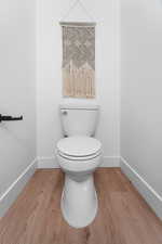 Bathroom with baseboards and wood finished floors