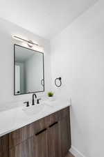 Bathroom with vanity and a textured ceiling