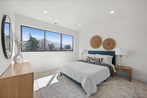 Bedroom with light colored carpet and recessed lighting