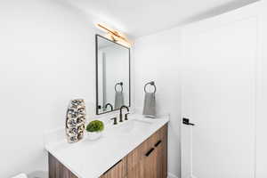 Bathroom featuring vanity and a textured ceiling