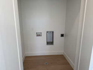 Laundry area featuring hookup for an electric dryer, light wood-type flooring, and hookup for a washing machine