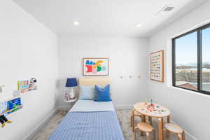 Bedroom featuring light carpet and recessed lighting
