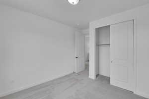 Unfurnished bedroom with carpet flooring and a closet