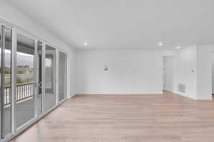 Unfurnished room with light wood-style floors and recessed lighting