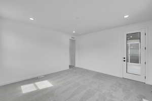 Carpeted spare room with recessed lighting