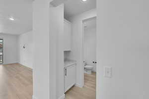 Bathroom with wood finished floors and recessed lighting