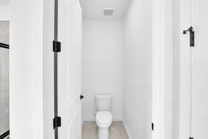 Bathroom featuring toilet and tile patterned floors