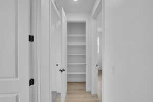 Corridor with light wood finished floors
