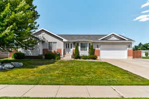 Ranch-style home featuring brick siding, an attached garage, concrete driveway, and stucco siding