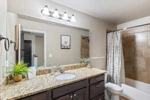 Full bathroom featuring vanity and shower / bathtub combination with curtain