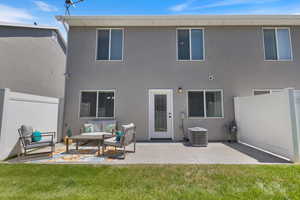 Rear view of property with a patio area and stucco siding
