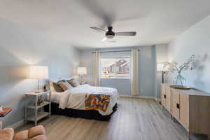 Bedroom with light wood-style flooring and ceiling fan