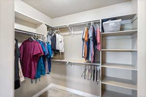 Walk in closet featuring wood finished floors