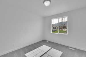 Carpeted empty room with baseboards
