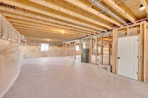 Basement featuring heating unit