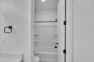 Bathroom with toilet and shower / tub combination
