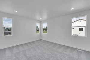 Spare room featuring carpet flooring and recessed lighting