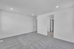 Carpeted spare room featuring recessed lighting