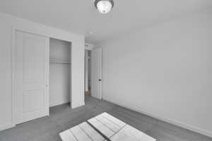 Unfurnished bedroom with carpet flooring and a closet