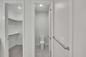 Bathroom with tile patterned flooring, recessed lighting, and a spacious closet