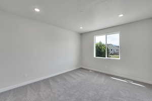 Empty room featuring carpet flooring and recessed lighting