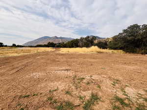 View of mountain backdrop featuring rural landscape
