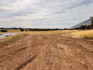 View of yard featuring a rural view and a mountain view