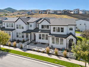 View of front of home featuring a residential view, board and batten siding, and a fenced backyard