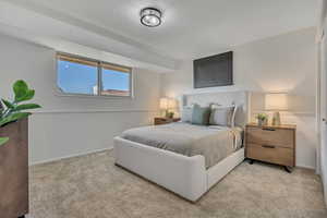 Bedroom featuring light colored carpet