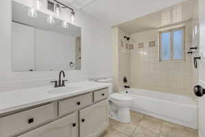 Bathroom featuring vanity, bathing tub / shower combination, and tile patterned flooring