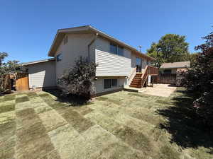 Back of property featuring stairway and a wooden deck