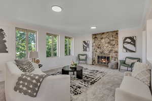 Living area with ornamental molding, carpet, and a stone fireplace