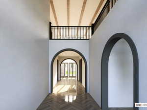 Hall featuring arched walkways and a towering ceiling