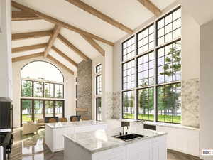 Building lobby featuring high vaulted ceiling and beam ceiling