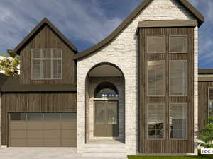View of front of home featuring a garage, driveway, and brick siding