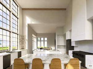 Kitchen with a center island, white cabinets, black range, and a towering ceiling