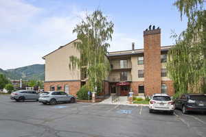 View of building exterior with uncovered parking