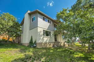 Back of property featuring a lawn