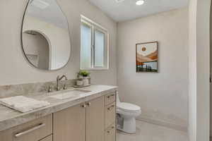 Bathroom with vanity and baseboards