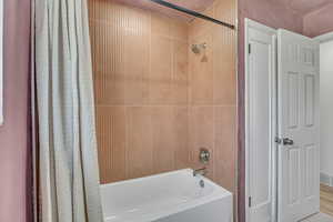 Bathroom featuring shower / bath combination with curtain