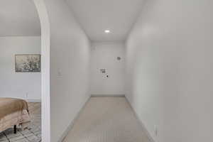 Corridor featuring arched walkways and recessed lighting