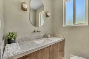 Bathroom featuring vanity and toilet