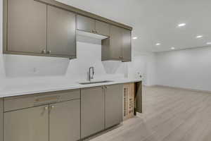 Kitchen featuring recessed lighting, gray cabinets, light wood-style flooring, and light countertops