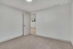 Empty room with baseboards and carpet