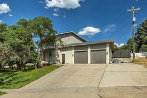 View of front of property with a garage, brick siding, and concrete driveway