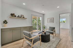 Living area with healthy amount of natural light, recessed lighting, and light wood-type flooring